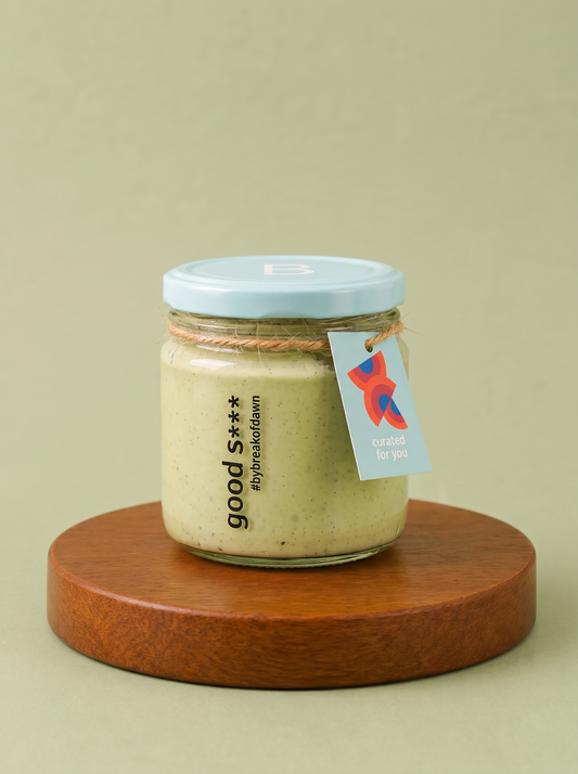 A jar of Break of Dawn high protein pesto pasta sauce on a wooden board
